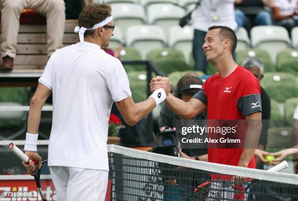 Denis Istomin of Uzbekistan shakes hands with Philipp Kohlschreiber of Germany after their match during day 2 of the Mercedes Cup at Tennisclub...