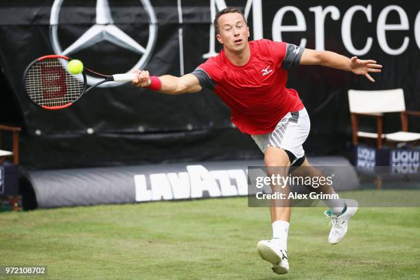 Philipp Kohlschreiber of Germany plays a forehand to Denis Istomin of Uzbekistan during day 2 of the Mercedes Cup at Tennisclub Weissenhof on June...
