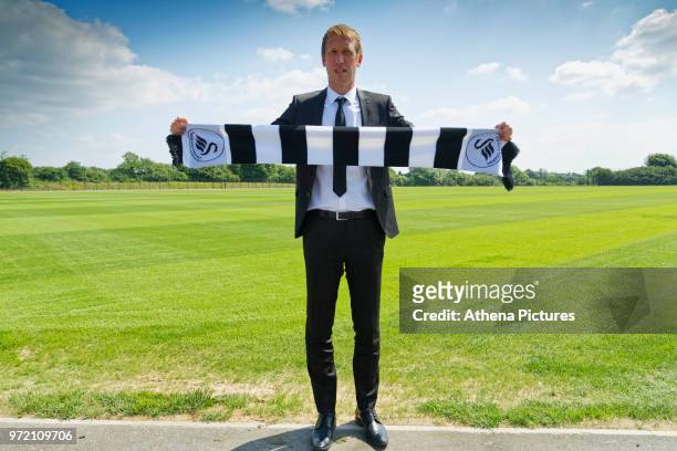 Manager Graham Potter holds a club scarf after the Swansea City Press Conference at The Fairwood Training Ground on June 12, 2018 in Swansea, Wales.