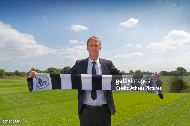 Manager Graham Potter holds a club scarf after the Swansea City Press Conference at The Fairwood Training Ground on June 12, 2018 in Swansea, Wales.