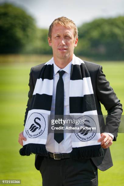 Manager Graham Potter holds a club scarf after the Swansea City Press Conference at The Fairwood Training Ground on June 12, 2018 in Swansea, Wales.