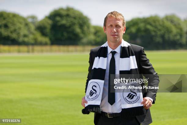 Manager Graham Potter holds a club scarf after the Swansea City Press Conference at The Fairwood Training Ground on June 12, 2018 in Swansea, Wales.