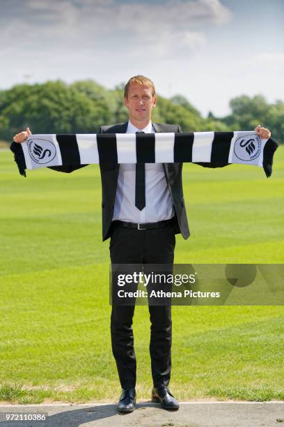 Manager Graham Potter holds a club scarf after the Swansea City Press Conference at The Fairwood Training Ground on June 12, 2018 in Swansea, Wales.