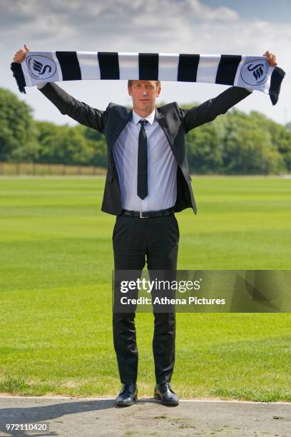 Manager Graham Potter holds a club scarf after the Swansea City Press Conference at The Fairwood Training Ground on June 12, 2018 in Swansea, Wales.