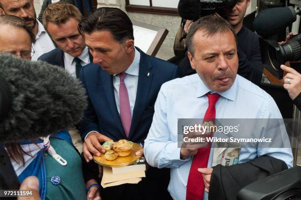 June 12: Anti-Brexit supporter shares pies as a part of 'Pies Not Lies' protest with Leave.EU Arron Banks and Andy Wigmore , as they arrive at...