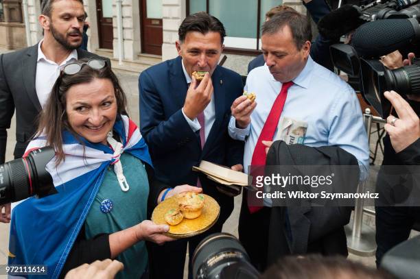June 12: Anti-Brexit supporter shares pies as a part of 'Pies Not Lies' protest with Leave.EU Arron Banks and Andy Wigmore , as they arrive at...