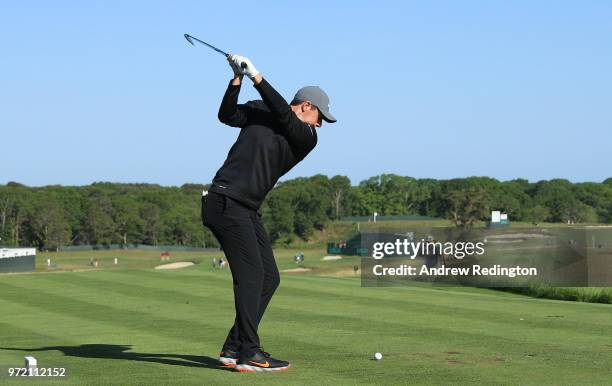 Rory McIlroy of Northern Ireland plays his shot from the first tee during a practice round prior to the 2018 U.S. Open at Shinnecock Hills Golf Club...