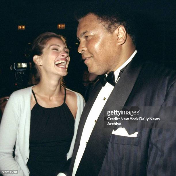 Actress Julia Roberts shares a laugh with Muhammad Ali at the Amnesty International USA Media Spotlight Awards presentations at Pier 60. Ali received...