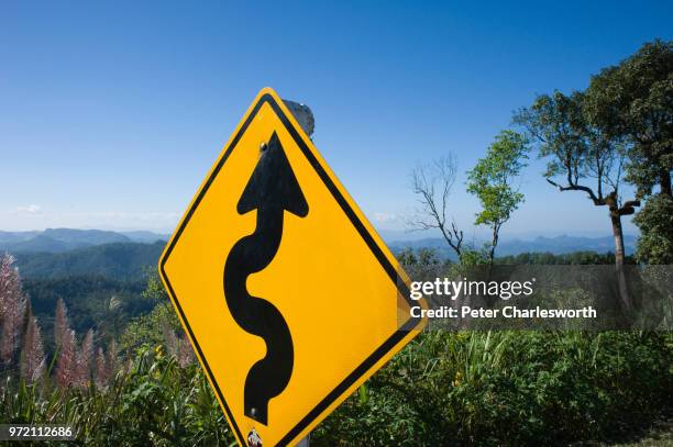 Very windy road signs by the side of the mountain road heading towards Mae Hong Son.