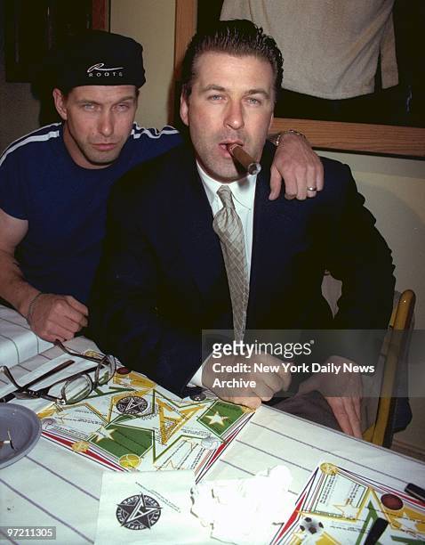 Alec Baldwin with cigar and brother Stephen Baldwin attending Evander Holyfield and Michael Moorer fight at the All Star Cafe.