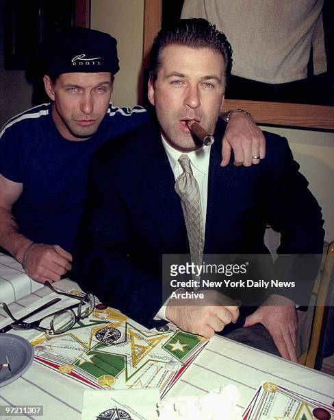 Alec Baldwin with cigar and brother Stephen Baldwin attending Evander Holyfield-Michael Moorer fight at the All Star Cafe.