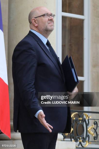 French Agriculture Minister Stephane Travert looks up to check if it is raining as he leaves the Elysee Palace after attending the weekly cabinet...