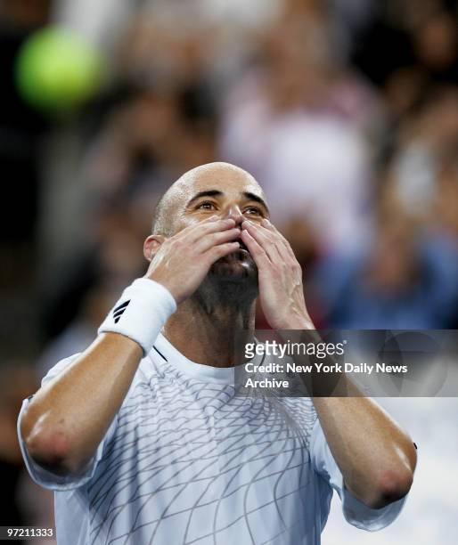 Andre Agassi of the U.S. Blows kisses to the crowd after defeating Marcos Baghdatis of Cyprus in five sets - 6-4, 6-4, 3-6, 5-7, 7-5 - during the...