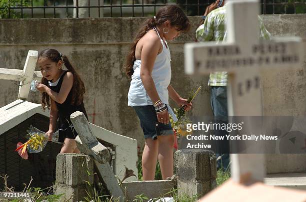 Adriana at burial of her father Bolivar Cruz who was shot dead in a robbery at his bodega in Queens last week when he pulled out a gun to protect his...