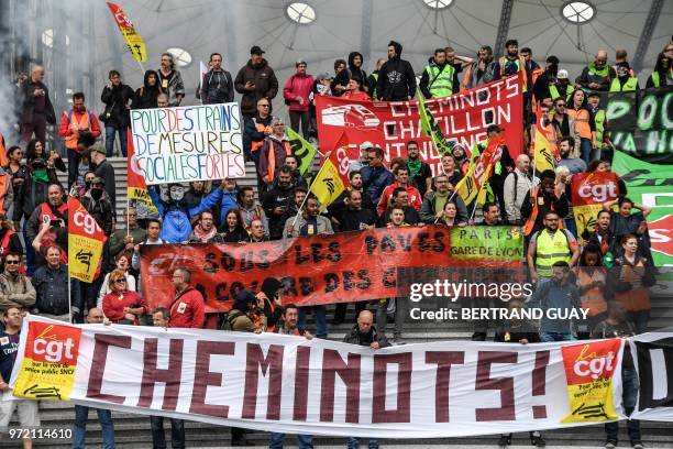 French railway workers demonstrate under the Grande Arche de la Defense on June 12, 2018 in Paris' business district of la Defense, during a 15th day...