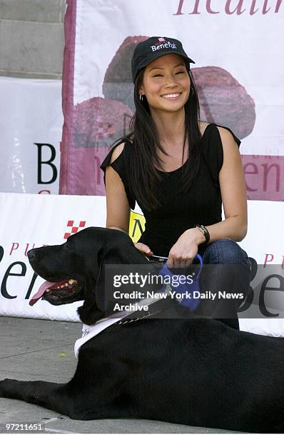 Actress Lucy Liu and her Labrador retriever, Luciano, are on hand at the Central Park band-shell to host a "dog health spa" sponsored by Purina to...