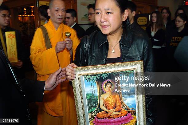 April Lao's cousin weeps as she leads a funeral procession for the Stuyvesant High School freshman during a traditional Buddhist service at the Chun...