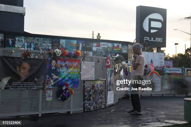 Visitor takes in the scene at the memorial to the 49 shooting victims setup at the Pulse nightclub where the shootings took place two years ago on...