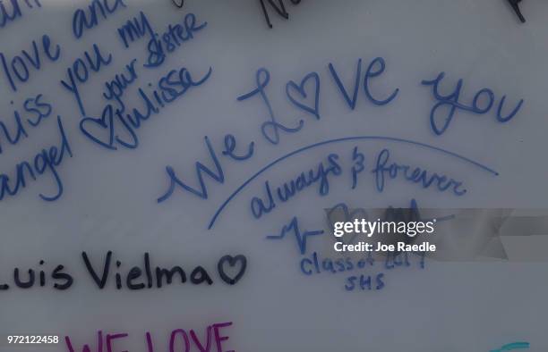 Messages are seen that are written on the Pulse sign at the memorial to the 49 shooting victims setup at the Pulse nightclub where the shootings took...