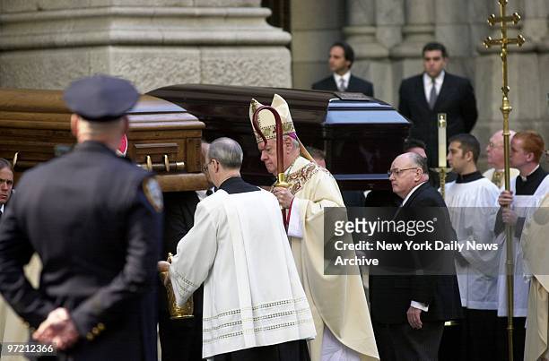 After the funeral Mass in St. Patrick's Cathedral, Archbishop Egan blesses the coffins of three of the four nurses killed in a freak accident in...