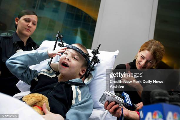 Aidan Fraser is all smiles as he's wheeled out of Montefiore Medical Center on a gurney with mom Suzanne at his side after a 20-day stay following...
