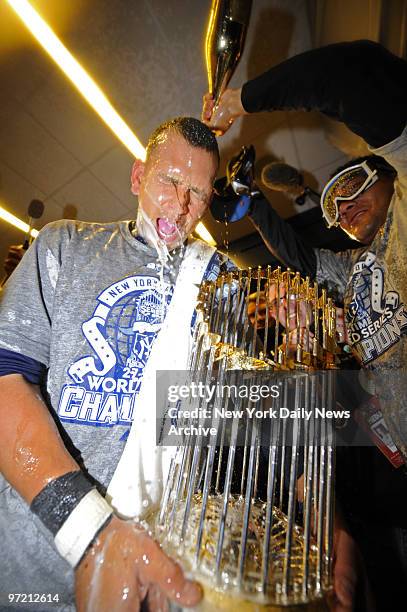 Alex Rodriguez gets a taste of the bubbly in the Yankees clubhouse after the New York Yankees win the World Series, four games to two, against the...