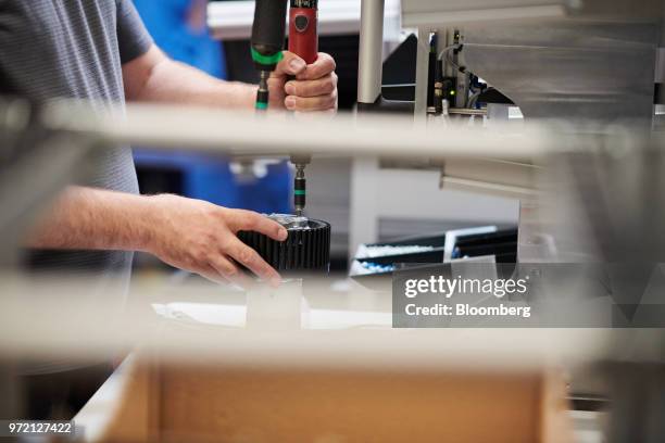 An employee works on air conditioning system component assembly line at the EBM-Papst GmbH ventilation system factory in Mulfingen, Germany, on...