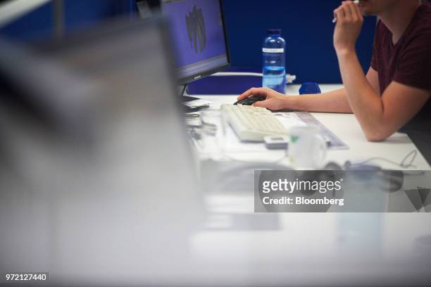 An employee works at a desktop computer in the product development department at the EBM-Papst GmbH ventilation system factory in Mulfingen, Germany,...
