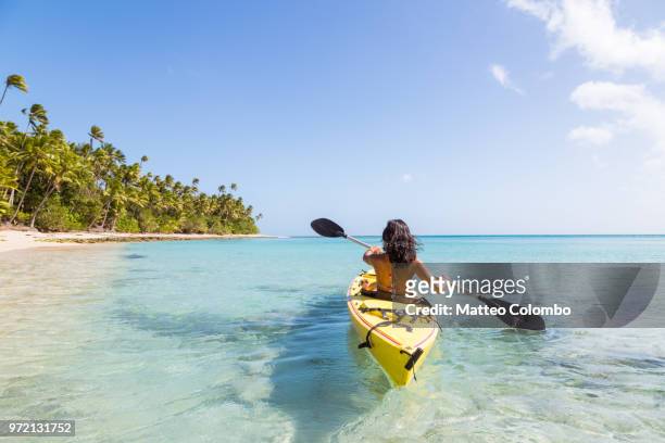 woman on kayak near beach in a tropical island, fiji - fiji stock pictures, royalty-free photos & images