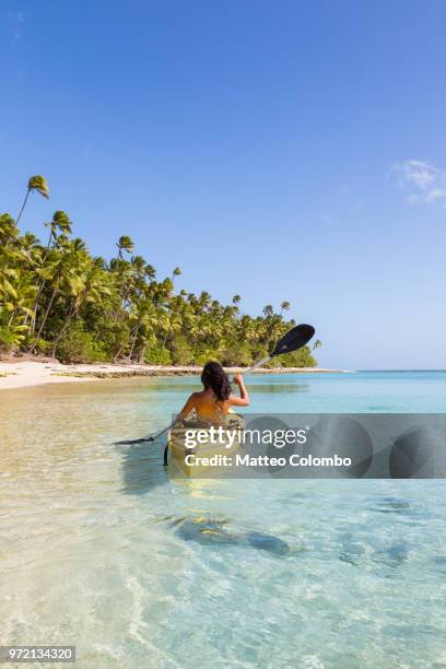 woman on kayak near beach in a tropical island, fiji - fiji people stock pictures, royalty-free photos & images