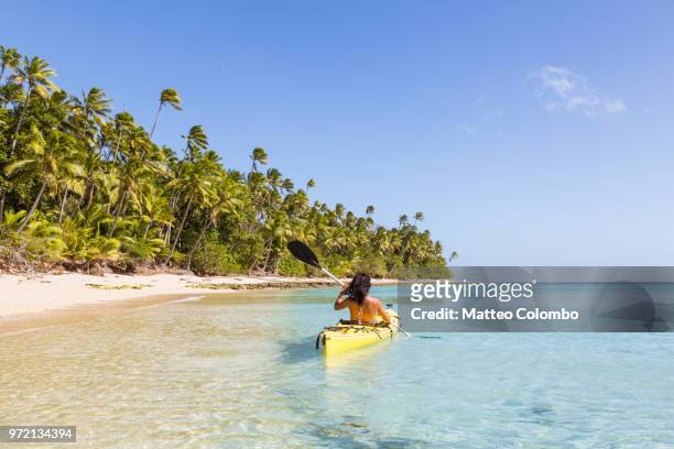 woman on kayak near beach in a tropical island, fiji - kayaker woman stock pictures, royalty-free photos & images