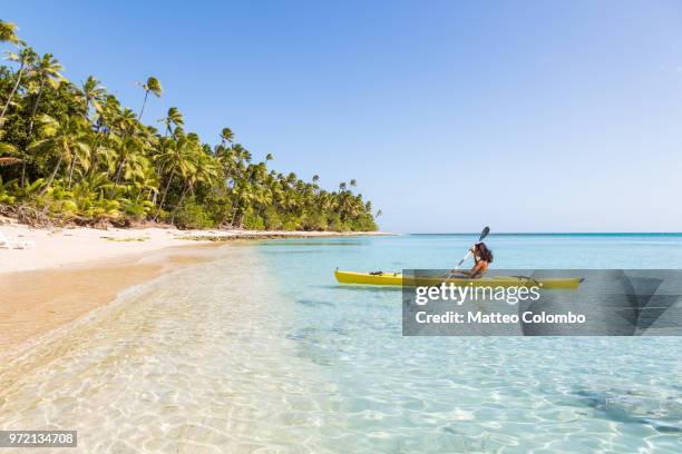 woman on kayak near beach in a tropical island, fiji - fiji people stock pictures, royalty-free photos & images