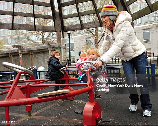 Jenn Heiss plays with her daughters Grace Heiss, 18 Months, Madison Heiss and friends son Darren Orlando in Battery Park City Tuesday. New census...