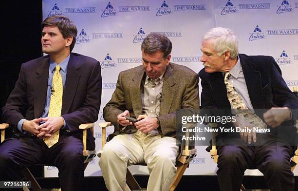 Steve Case, Chairman and CEO of America Online, Gerald Levin, chairman and CEO of Time Warner, and Ted Turner, vice chairman of Time Warner, sit...
