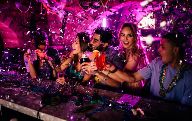  friends celebrating mardi gras with drinks at night club - night club stock pictures, royalty-free photos & images