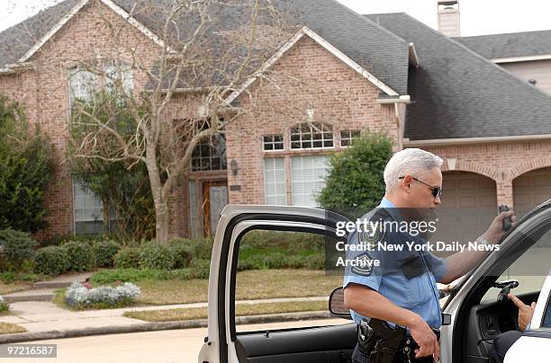 Police officer stands outside the Houston home of astronaut Lisa Marie Nowak. Nowak, a 43-year-old Navy captain, is charged with attempting to kidnap...