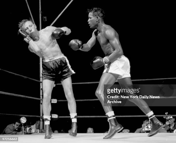 Pop-eyed Charley Fusari bounces off ropes in 10th round after taking one of Ray Robinson's rights to the head that had his knees buckling and the...