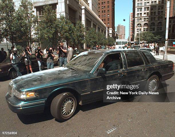 Lincoln Town Car belonging to mother-and-son con artist team, Sante Kimes and Kenneth Kimes, is driven out of FBI Headquarters covered with...