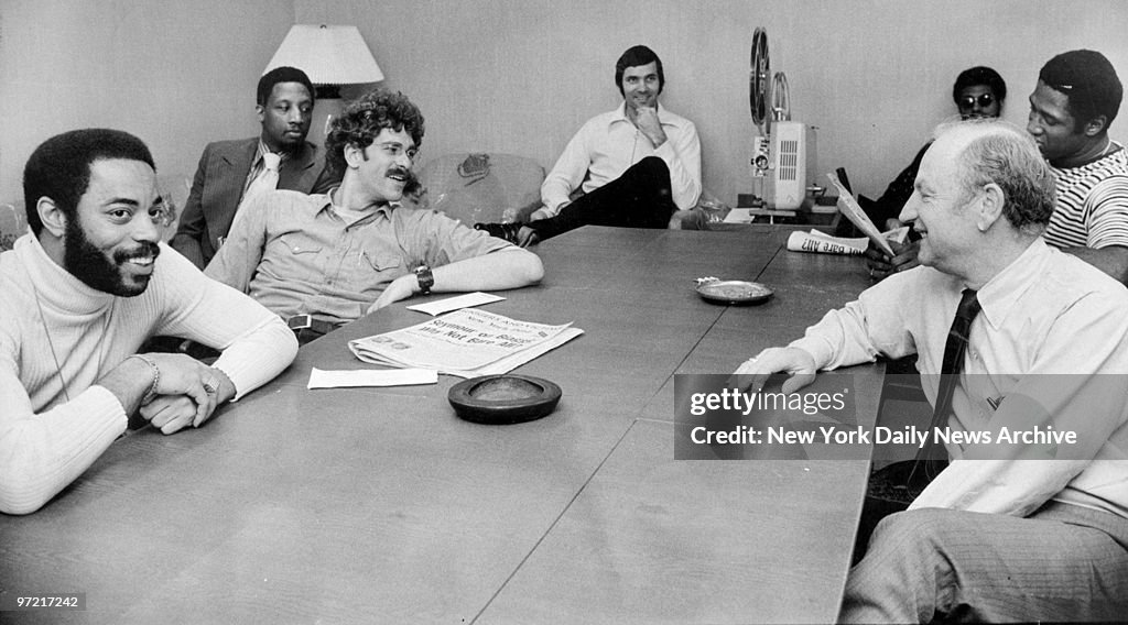 A relaxed bunch of New York Knicks sit around projector with