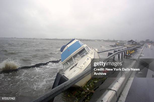 Small boat is jammed up against a bridge leading to Hutchinson Island, a barrier island, after Hurricane Frances roared through South Central Florida.