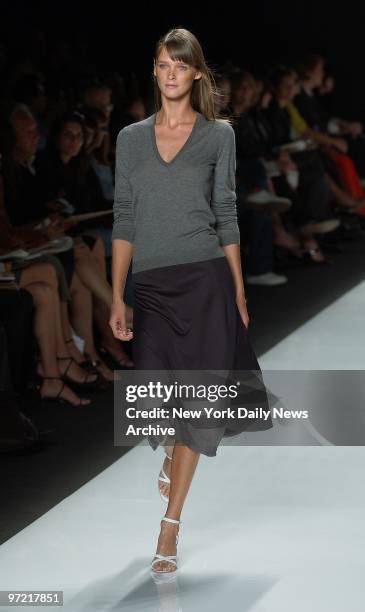 Model wears grey cashmere sweater over a blue silk skirt during the showing of Michael Kors' new collection as part of Spring Fashion Week 2003.