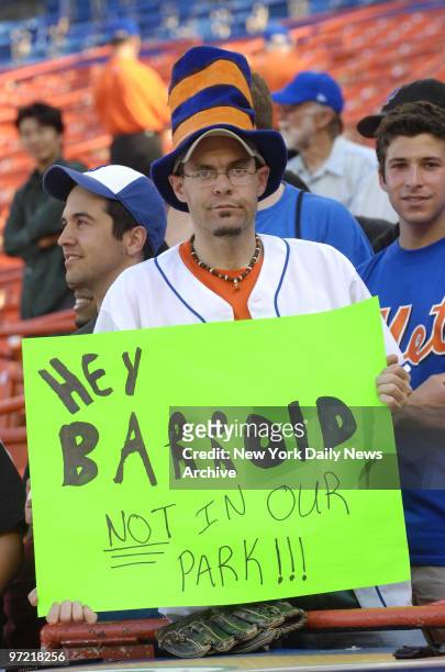 Surly looking New York Mets fan holds a sign reading, "Hey Barroid, not in our park!!!" - referring to San Francisco Giants' Barry Bonds' alleged...