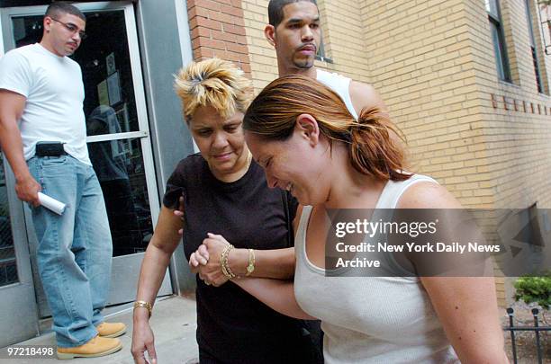 Tearful Melissa Vincens, wife of off-duty cop Eric Concepcion, is helped into her building by mother-in-law Roxanne Marsan, followed by Concepcion's...