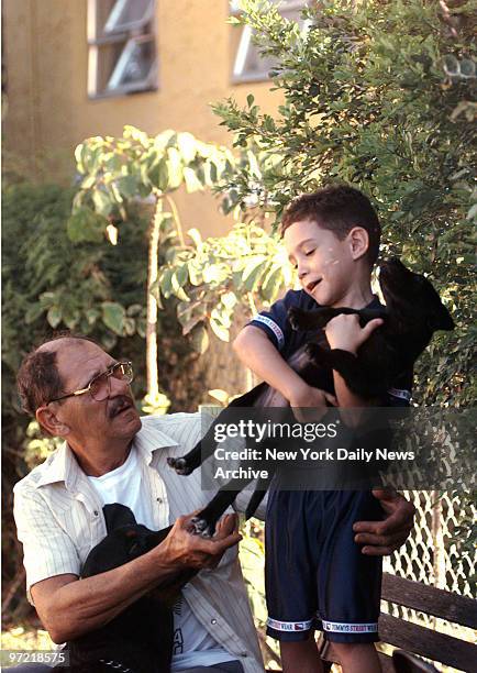 Year-old Cuban boy Elian Gonzalez plays outside his temporary home in Little Havana, Miami with his new puppy named Dolphin, his great uncle Delfin...