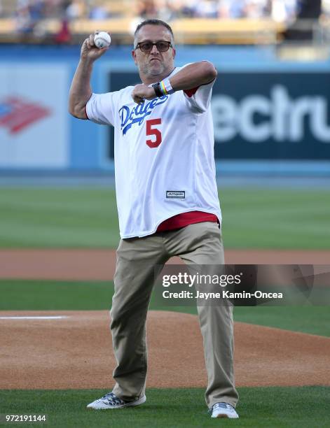 The first openly gay MLB umpire Dale Scott throws out the first pitch before the game between the Los Angeles Dodgers and the Atlanta Braves on LBGT...