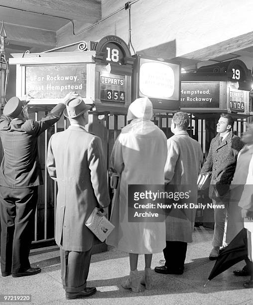 Brand-new closed-circuit television set flickers forth with train information for Long Island Rail Road commuters at Pennsylvania Station. An usher...