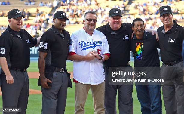 The first openly gay MLB umpire Dale Scott poses with umpires Todd Tichenor, Alan Porter, Bill Miller, NBA referee Bill Kennedy and Angel Hernandez...
