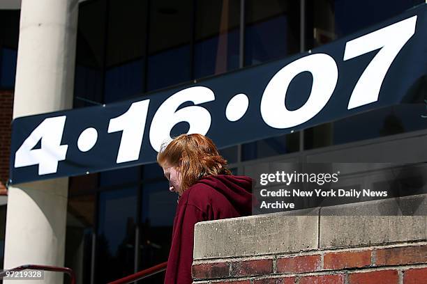 Virginia Tech student sits under a banner marking the date of yesterday's school massacre, in which 32 people were killed when gunman Cho Seung-Hui a...