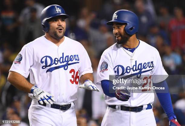 Adam Liberatore catches his breath as he walks to the dugout with Matt Kemp of the Los Angeles Dodgers after scoring a run from first base in the...