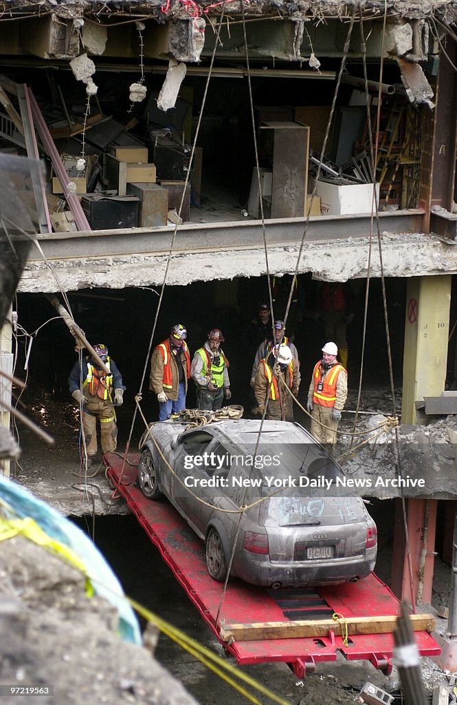 A car is placed on a hoist to be removed from the B2 level o